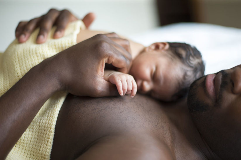 Father holding baby in skin-to-skin contact