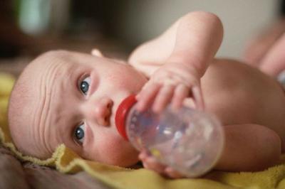 Малыш пьет воду с бутылочки