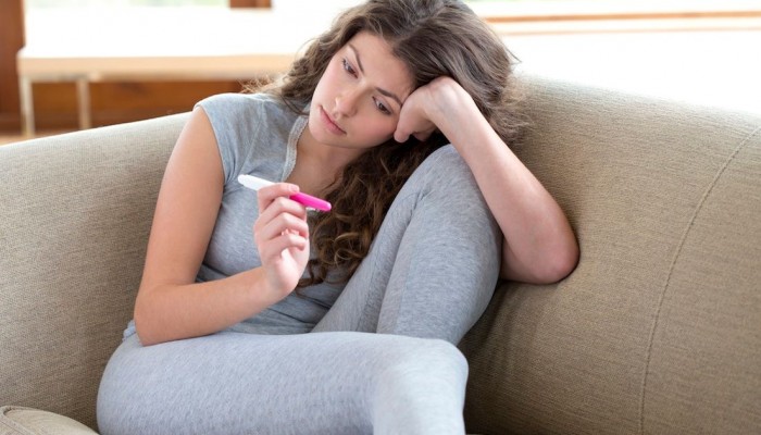 Young-Woman-with-Pregnancy-Test