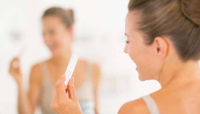 happy-woman-looking-at-pregnancy-test_0